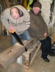 Brian, with help from Loughie saws through the pine block.